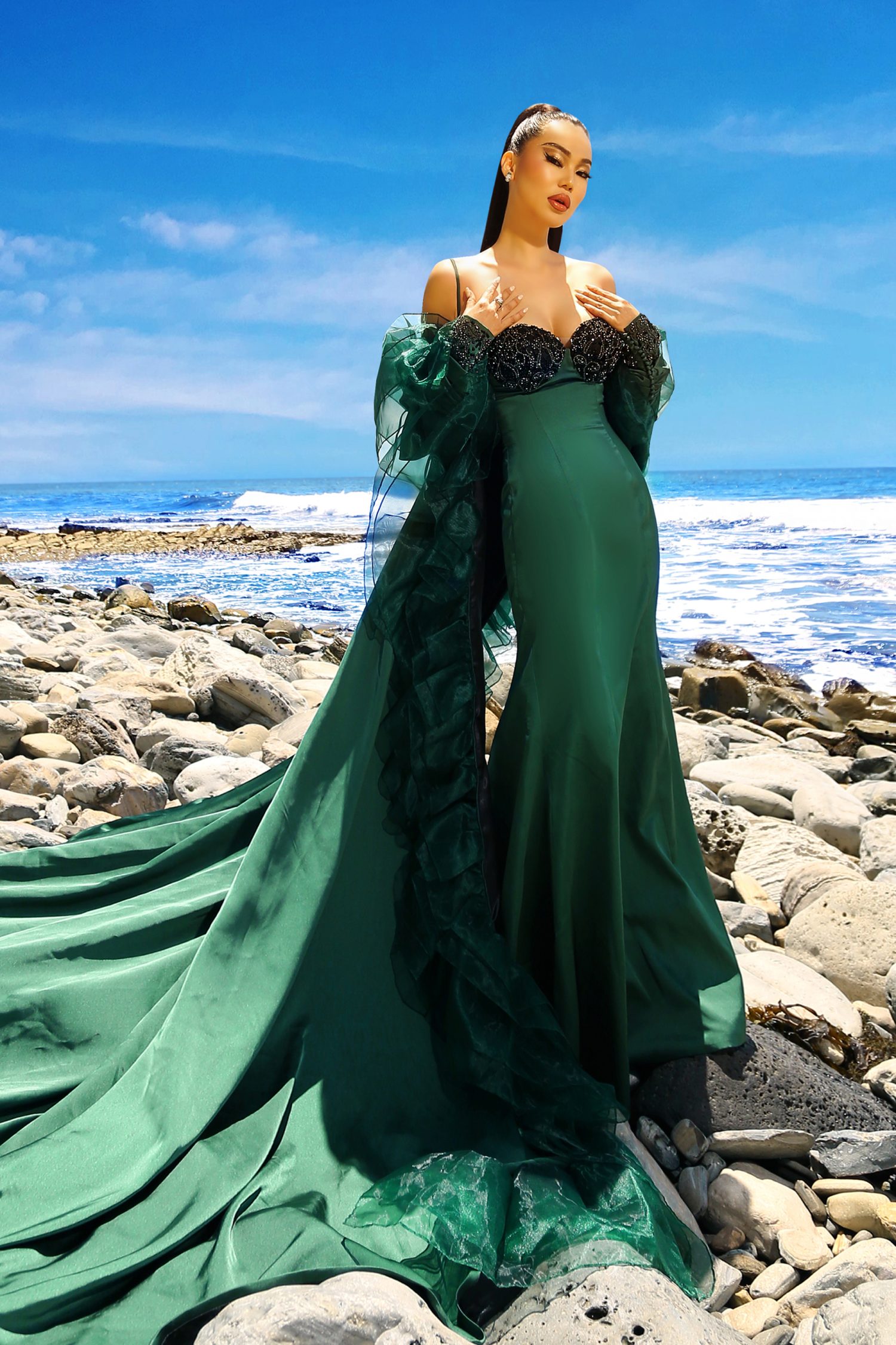 Strapless Gown Embrace the allure of the strapless gown, a symbol of timeless elegance and modern sophistication. This emerald green couture piece, with its flawless strapless bodice, is designed to celebrate the contours of your figure. The V-shaped neckline plunges with daring grace, offering a glimpse of allure while maintaining an air of chic poise. Satin Fabric The gown is crafted from the finest satin fabric, known for its lustrous sheen and luxurious feel. The material wraps around you in a loving embrace, enhancing your natural grace with its smooth texture. The satin catches the light with every movement, creating a dynamic display of shimmering elegance. Organza Ruffled Cape Adding a dramatic flair to the ensemble is the organza ruffled cape. This statement piece flows from the shoulders like a waterfall of fabric, its ruffles dancing with each step you take. The organza is sheer yet structured, creating a visual spectacle that is both ethereal and commanding. Cape Sleeve Dress The cape sleeve dress design merges the freedom of a cape with the formality of a gown. The sleeves drape beautifully, offering a unique silhouette that is both avant-garde and reminiscent of classic Hollywood glamour. This design choice speaks to a bold fashion sense, willing to push boundaries while respecting tradition. Devon Couture Devon Couture is the artisan behind this magnificent creation. A name that evokes images of bespoke tailoring and exquisite designs, Devon Couture stands at the forefront of fashion innovation. This gown is a testament to their mastery of the craft, a piece that transcends trends to become a timeless icon of style. In this gown, you are not merely attending an event; you are the event. The strapless design, the satin fabric, the organza cape—all come together to create a masterpiece that is the very definition of couture. As you make your entrance, the gown becomes an extension of your persona, a reflection of your grace, and a symbol of your indomitable style. Embrace the night with the assurance that comes from wearing a piece of Devon Couture, knowing that in this gown, you are the epitome of sophistication. Let the strapless gown with its satin fabric and organza ruffled cape be your armor and your crown as you navigate the evening, a true vision of modern-day royalty. With every step, the gown tells a story of elegance, allure, and a romance with fashion that is deep and enduring. You are not just making an appearance; you are creating a moment—a moment that will be remembered long after the night has ended. Let this gown be your declaration of independence, a statement that in the world of fashion, you are a force to be reckoned with.