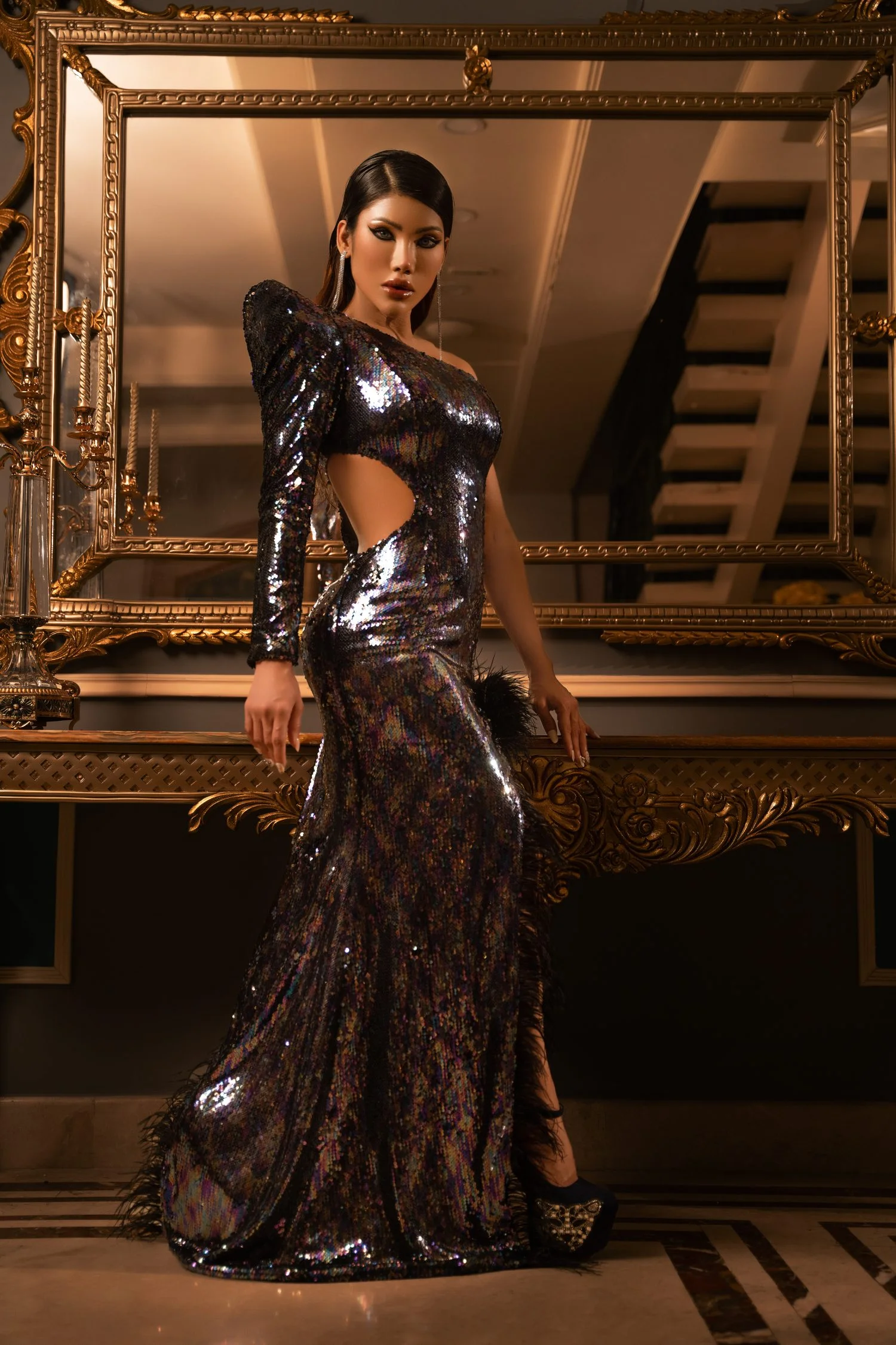 One Shoulder Gown in Sequins Fabric  Step into a world where fashion meets fantasy, and elegance is etched in every thread. Presenting the Devon Couture by Jannat Akhi, a collection that redefines luxury with its one-shoulder gown in sequins fabric. This masterpiece is a harmonious blend of tradition and modernity, designed for the woman who is both a muse and a queen. Long Train with High Thigh Slit  The gown’s silhouette is a testament to the timeless beauty of the long train, which sweeps behind you like a whisper of royal lineage. The high thigh slit is a bold statement of contemporary grace, offering a glimpse of adventure with every step you take. Built-in Shoulder Pad and Daring Neckline  Structured to perfection, the built-in shoulder pad adds an architectural element to the gown, creating a profile that is both commanding and sensual. The daring neckline is a daring invitation to the world, showcasing confidence and a touch of mystique. Hand Beadworks with Built Bonding  Every bead is a note in the opus of this gown’s design, handcrafted with precision and passion. The built bonding technique ensures that each embellishment is not only a visual delight but also a testament to the art of couture. Dior, Devon Couture by Jannat Akhi The Devon Couture by Jannat Akhi is not just a dress; it’s a dream woven into reality. It’s an invitation to step into a realm where every detail is a reflection of your innermost desires and every stitch is a promise of unparalleled elegance. Let this gown be the prologue to your story of splendor, a story that begins the moment you adorn yourself with this emblem of enchantment.