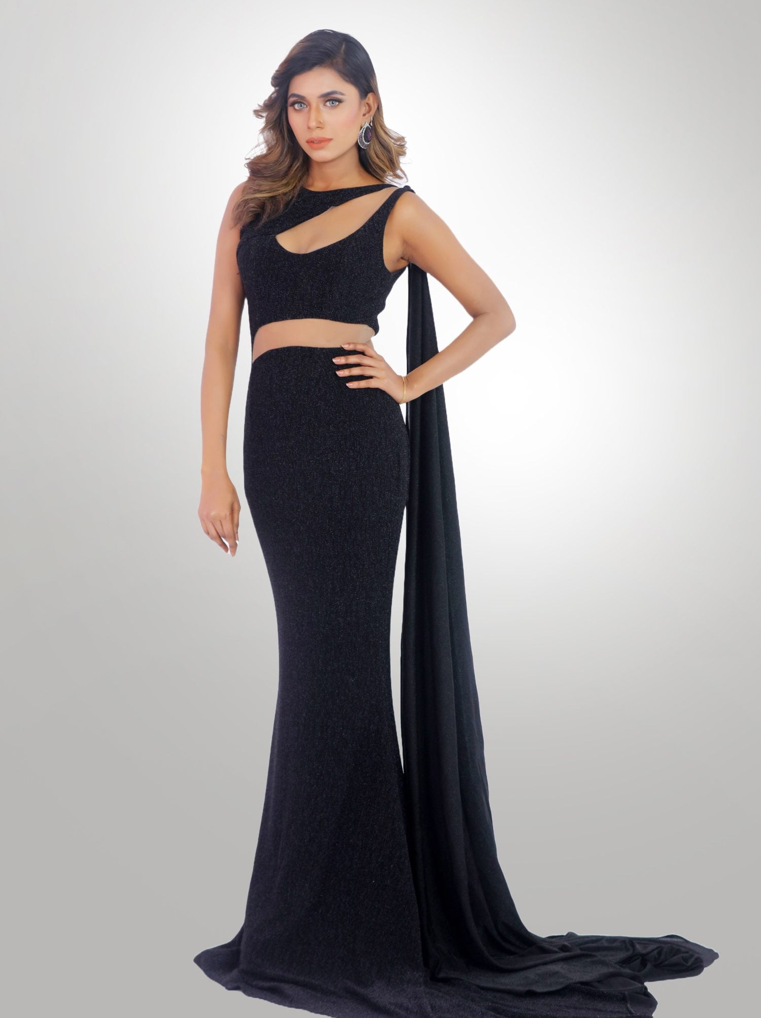 Black Ball Gown Step into the night with the epitome of elegance – our Black Ball Gown. Crafted with precision and passion, this gown is not just a piece of clothing; it’s the armor of the modern-day queen, ready to conquer the ballroom. Floor-Length Skirt with Stretchy Fabric The Floor-Length Skirt cascades gracefully to the ground, a river of fabric that flows with every step you take. The Stretchy Fabric clings softly, offering comfort without compromising on style, ensuring you’re the epitome of both beauty and ease. Full-Length Gown with Hourglass Silhouette Our Full-Length Gown is a tribute to the timeless hourglass figure. It hugs your curves in a loving embrace, highlighting the small of your waist and blossoming into a full skirt that dances with you through the night. Vogue Essence, Devon Couture by Jannat Akhi Designed by the illustrious Jannat Akhi, this gown is a masterpiece from the Devon Couture collection. Each stitch tells a story of luxury, each fold a verse of sophistication. The Fitted Bodice of our black ball gown is a testament to the art of tailoring. It sculpts your form, creating an Hourglass Silhouette that radiates confidence and allure. The High-Quality Stretchy Fabric promises comfort, allowing you to glide across the dance floor with the grace of a swan. As you make your entrance, the Full, Floor-Length Skirt billows like a cloud around you. With each step, the fabric undulates, revealing its opulent weight and luxurious texture. The Round Neckline is a frame for your visage, drawing eyes to your collarbones and décolletage, while the Black Color is a declaration of sophistication—a canvas upon which your personality shines brightly. This ball gown is more than a dress; it’s a narrative of grandeur and charm. The Small Waistline adds a note of finesse, while the Full Length ensures your presence is felt in every corner of the room. You won’t just turn heads—you’ll stop time.