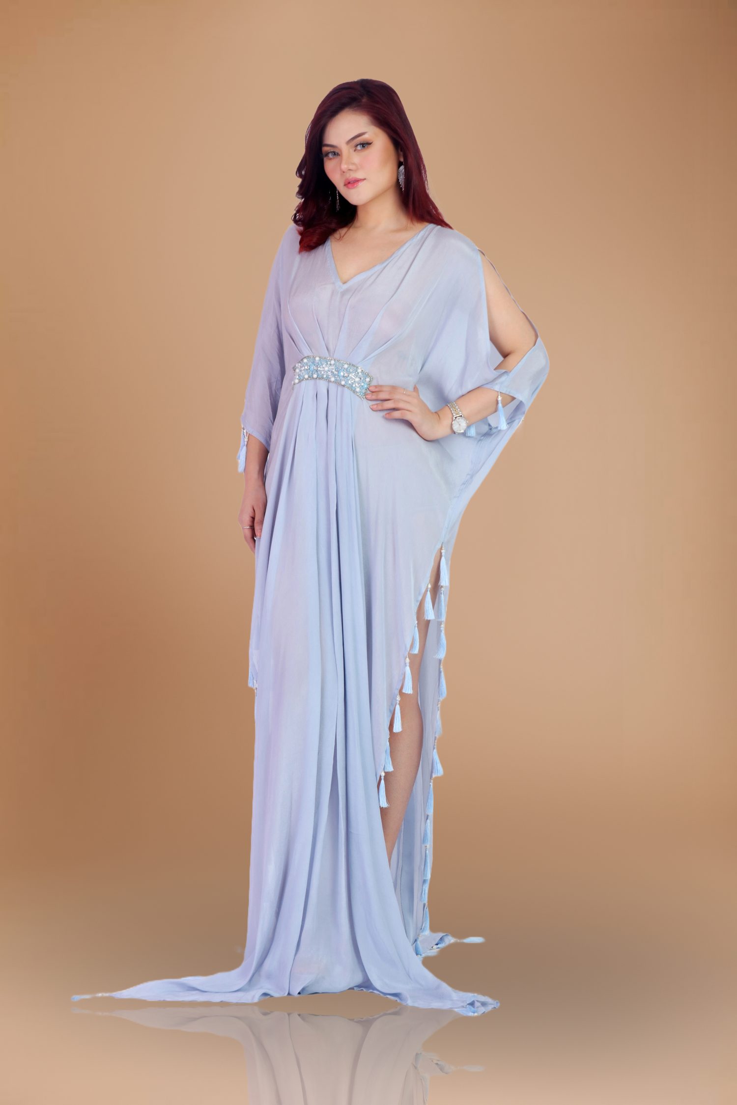 Lavender Kaftan: A Symphony of Elegance Step into a world of sophistication and grace with our Lavender Chiffon Kaftan—a masterpiece that transcends mere fashion and becomes an unforgettable experience. Crafted meticulously by the renowned designer Jannat Akhi, this floor-length kaftan envelops you in ethereal beauty. Let’s explore the exquisite details that make this Lavender Kaftan a true work of art. The V-Neckline: A Neck-Length Elegance The Lavender Chiffon Kaftan features a flattering V-neckline that elongates your neck and frames your décolletage. Imagine the delicate chiffon cascading gracefully, revealing just enough skin to captivate without overpowering. Whether you’re attending a gala, a beachside soirée, or an intimate dinner, this neckline ensures you stand out with poise and allure. Natural Waistline: Subtle Cinching, Effortless Glamour The kaftan’s natural waistline subtly cinches, creating a flattering silhouette that celebrates your curves. It’s elegance in simplicity—a gentle embrace that accentuates your figure without compromising comfort. As you move, the chiffon billows around you, evoking a sense of freedom and confidence. Beadwork: A Dance of Light and Intricacy Adorned with delicate beadwork, the Lavender Kaftan sparkles like stardust. Each bead catches the light, casting a mesmerizing glow as you glide through the room. The intricate patterns—carefully handcrafted by Devon Couture—add depth and dimension, turning the kaftan into wearable art. Whether it’s moonlit evenings or sun-kissed afternoons, you’ll be a vision of opulence. Side Slit: A Hint of Allure The side slit is the kaftan’s secret weapon—a subtle touch of allure that reveals just enough leg as you walk. Picture yourself at a glamorous event, the chiffon swaying with every step, the slit hinting at hidden mysteries. It’s sophistication with a playful twist, leaving an indelible impression on everyone you encounter. Chiffon Fabric: Light as Air, Luxurious as Dreams Chiffon—the fabric of dreams—drapes effortlessly, creating movement and fluidity. Imagine the soft lavender fabric against your skin, kissed by the evening sun. It’s weightless yet substantial, allowing you to dance, mingle, and enchant without constraint. The Lavender Chiffon Kaftan is more than clothing; it’s an extension of your elegance. Essence, Devon Couture by Jannat Akhi: A Legacy of Glamour Jannat Akhi, the visionary behind Devon Couture, weaves magic into every stitch. Her designs transcend trends, capturing timeless beauty. With the Lavender Chiffon Kaftan, she invites you to embrace sophistication, leaving an indelible mark wherever you go. It’s not just a garment—it’s an ode to elegance.