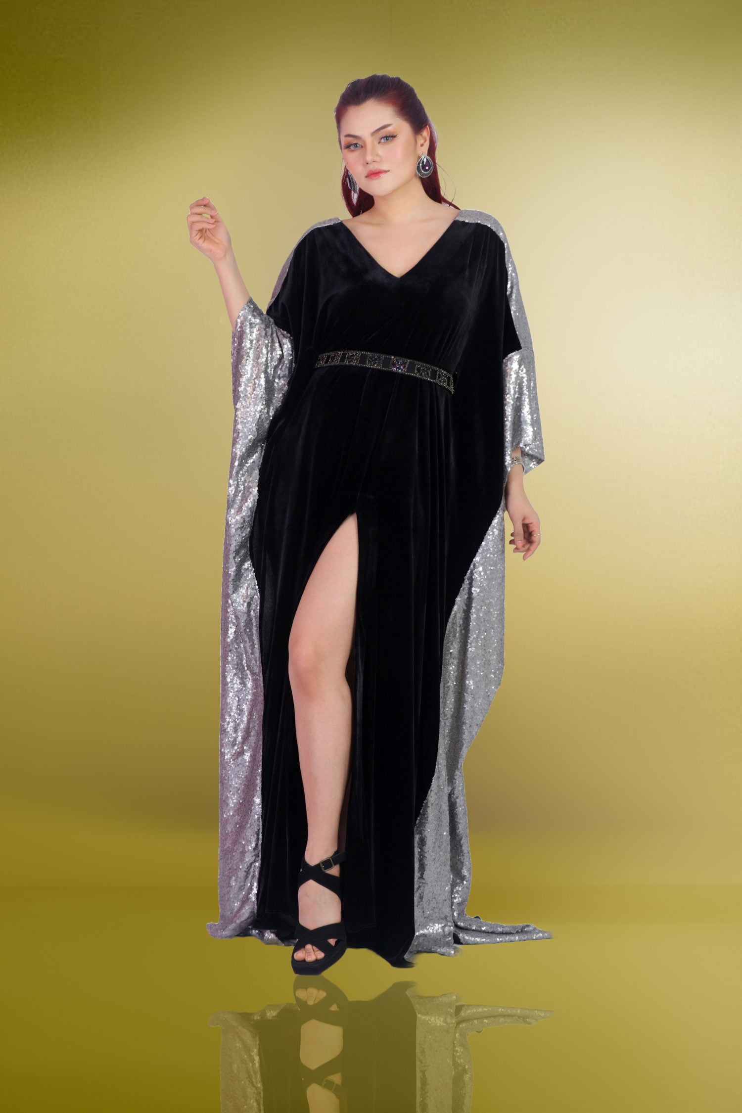 Kaftan Fit with Floor Length The Black Velvet Kaftan is designed with a fit that flatters every curve, flowing gracefully to the floor. The silhouette is both regal and modern, a perfect blend of tradition and contemporary style. The floor-length design pools around your feet, creating a dramatic effect that is both captivating and elegant. As you move, the velvet fabric flows with you, creating a mesmerizing visual that is sure to leave a lasting impression. The kaftan’s fit is tailored to perfection, hugging your body in all the right places while allowing for ease of movement. The luxurious velvet fabric feels soft against your skin, adding to the overall sense of comfort and opulence. This is a dress that is meant to be worn with confidence, a piece that makes you feel powerful and beautiful. Whether you’re attending a gala, a formal event, or a special occasion, this kaftan is the perfect choice for making a grand entrance. Beaded Belt with Neckline Plunges One of the standout features of the Black Velvet Kaftan is the beaded belt that cinches the waist. Each bead is a tiny universe, shimmering against the black expanse of the velvet fabric. The beaded belt is not just a decorative element; it’s a promise of opulence and sophistication. As you fasten the belt, you become a queen – regal, powerful, and unapologetically adorned. The beading adds a touch of sparkle and glamour, elevating the overall look of the kaftan. The neckline plunges into a V, framing your collarbones and adding a touch of sensuality to the design. It’s a canvas for jewels or bare skin – your choice. The plunging neckline is both daring and elegant, a perfect balance that enhances your natural beauty. Imagine standing under chandeliers, the velvet hugging your curves, the beaded belt shimmering in the light. This is a dress that makes you feel like royalty, a piece that embodies grace and sophistication. Heirloom with Velvet Kaftan Sweeps The Black Velvet Kaftan is more than just a dress; it’s an heirloom, a piece of art that is meant to be cherished and passed down through generations. The velvet fabric is plush and decadent, cradling you like a lover’s embrace. The front slit reveals a hint of leg, adding a touch of allure to the design. As you move, the velvet catches the light, casting shadows that dance with your every step. This is a dress that tells a story, a piece that is steeped in history and elegance. The kaftan’s design is timeless, a perfect blend of tradition and modernity. The floor-length silhouette flows gracefully, creating a dramatic effect that is both captivating and elegant. The beaded belt cinches the waist, adding a touch of sparkle and glamour. The plunging neckline frames your collarbones, adding a touch of sensuality to the design. This is a dress that is meant to be worn with confidence, a piece that makes you feel powerful and beautiful. Devon Couture by Jannat Akhi The Black Velvet Kaftan is a masterpiece by Devon Couture, designed by the talented Jannat Akhi. Known for her exquisite designs and attention to detail, Jannat Akhi has created a piece that is both timeless and modern. The kaftan is a testament to her skill and creativity, a piece that embodies grace and sophistication. Jannat Akhi’s designs are known for their luxurious fabrics, intricate details, and impeccable craftsmanship. The Black Velvet Kaftan is no exception, with its plush velvet fabric, beaded belt, and plunging neckline. This is a dress that is meant to be cherished, a piece that is steeped in history and elegance. When you wear this kaftan, you’re not just dressed; you’re adorned. You’re embodying an era of grace and sophistication, a lineage of elegance that is passed down through generations. In summary, the Black Velvet Kaftan by Devon Couture and Jannat Akhi is more than just a dress; it’s an ode to grace and sophistication. It’s a piece that whispers secrets, that invites admiration. Are you ready to step into the spotlight?